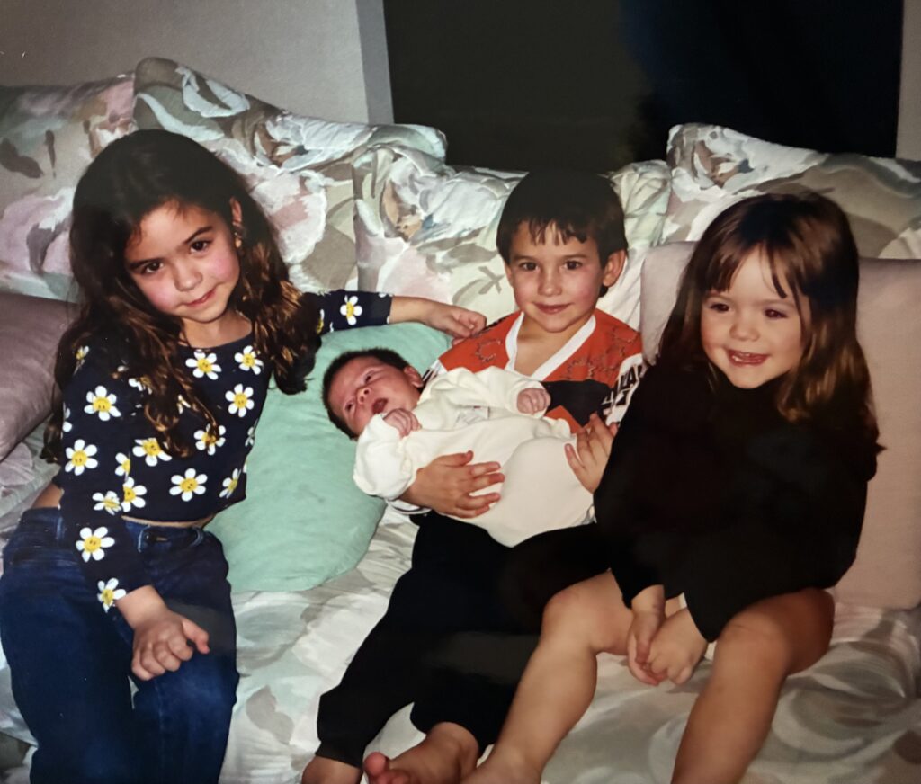 Davis Schneider (center) with his brother Stephen and two sisters.